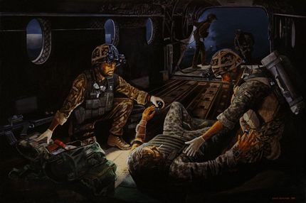 Military Medics treating a casualty on a Chinook helicopter during a night operation