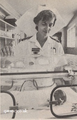 Captain Joan Thornley qaranc with tiny premature baby incubator