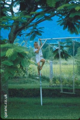 child climbing swing Nepal mountains